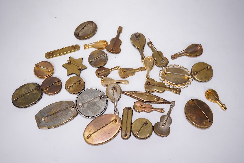 A collection of thirty-one micro-mosaic brooches, including fourteen mixed guitar and banjo shaped brooches, six large oval brooches and seven smaller brooches, three long brooches and a star shaped brooch. Condition - g